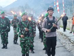 Polres Tolikara Hadiri Upacara Taptu dan Pawai Obor HUT RI ke-80 di Kabupaten Tolikara